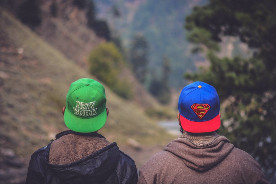 Shallow Focus Photography Of Two Men Wearing Caps photo