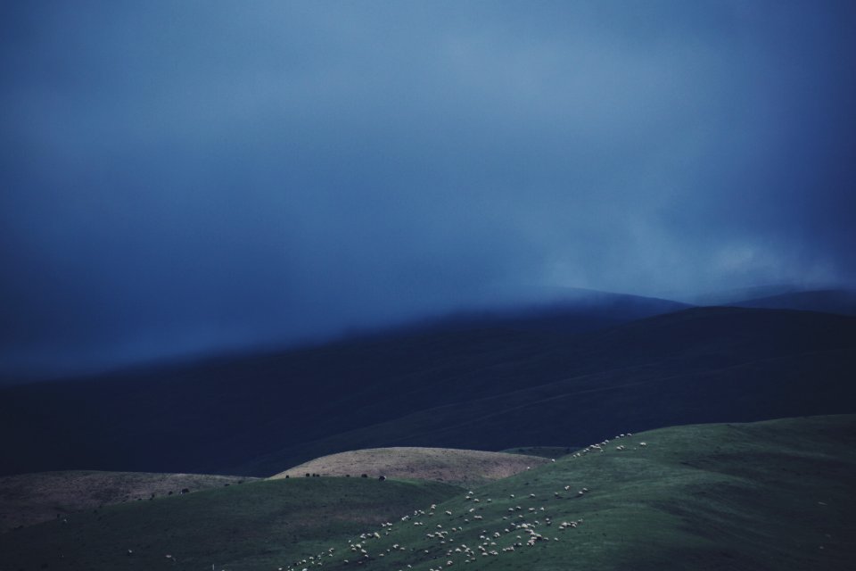 Mountain Range Under Cloudy Sky