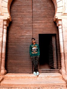 Man In Green Long-sleeved Top And Camouflage Pants