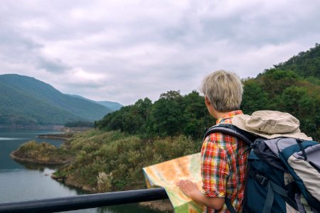 Man In Red Yellow Blueand White Plaid Collared Top With Blue And Gray Backpack