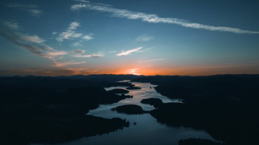 Aerial Photography Of Water Beside Forest During Golden Hour