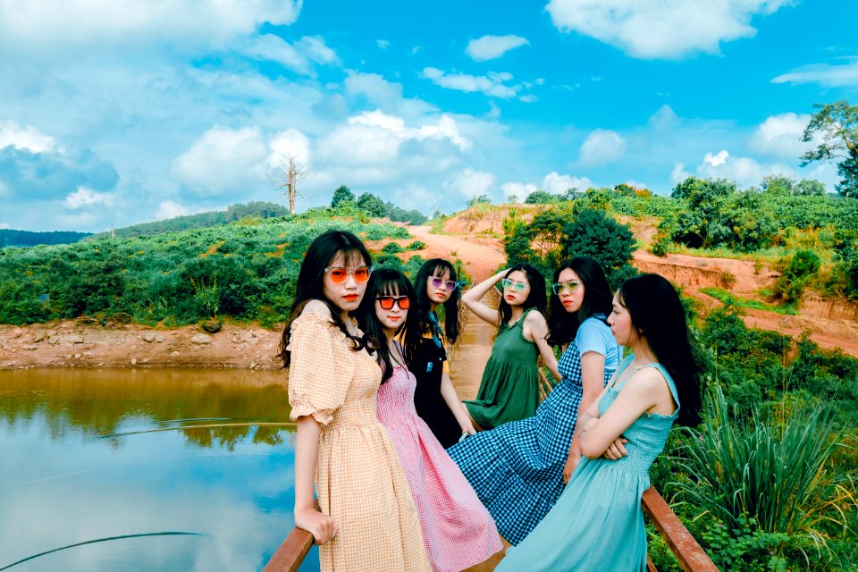 Photo Of Six Woman Sitting On Dock Fence