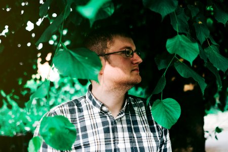 Man In Eyeglasses Standing Under Tree photo