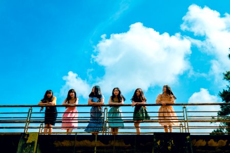 Six Women Wearing Mini Dresses Leaning On Bridges Rail photo