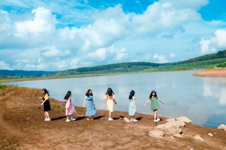 Six Girl Standing Beside Body Of Water photo