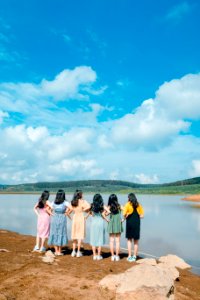 Six Women Facing Body Of Water Taking Picture photo