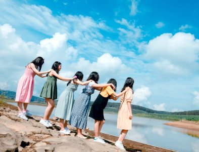 Six Women Standing Near Body Of Water photo