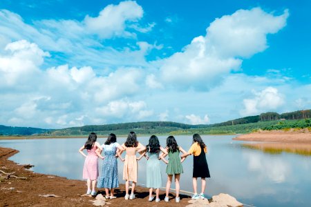 Group Of Girls Standing Beside River photo
