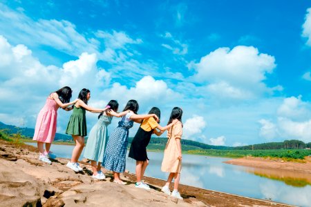 Six Women Standing Near Body Of Water photo