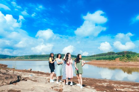 Four Women Standing Near Lake photo