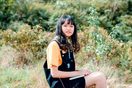 Shallow Focus Photography Of Woman In Yellow Shirt And Black Dungaree photo