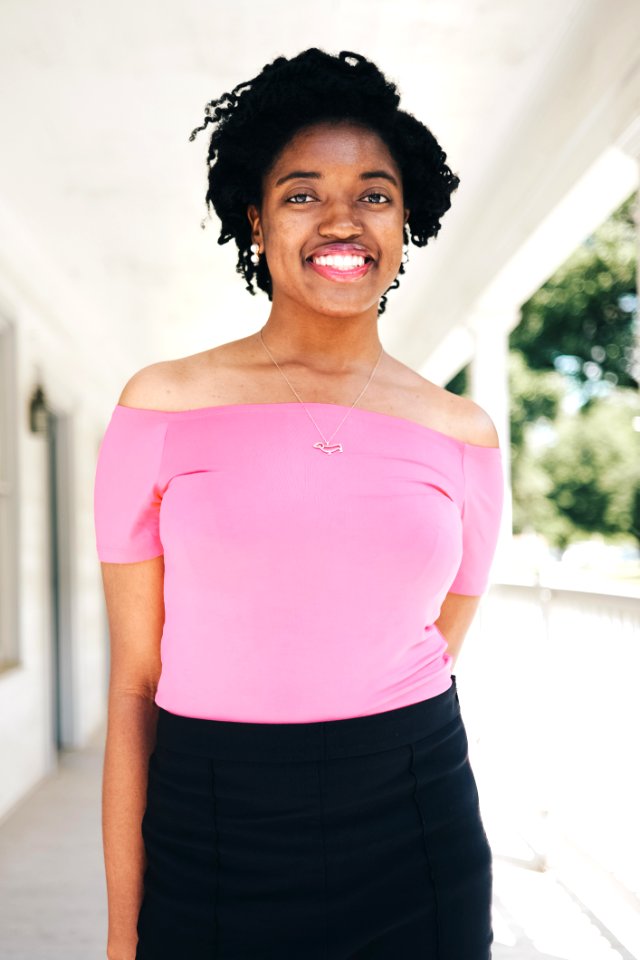 Smiling Woman Wearing Pink Off-shoulder Short-sleeved Blouse And Black Skirt Selective Focal Photo