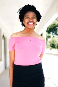 Smiling Woman Wearing Pink Off-shoulder Short-sleeved Blouse And Black Skirt Selective Focal Photo photo