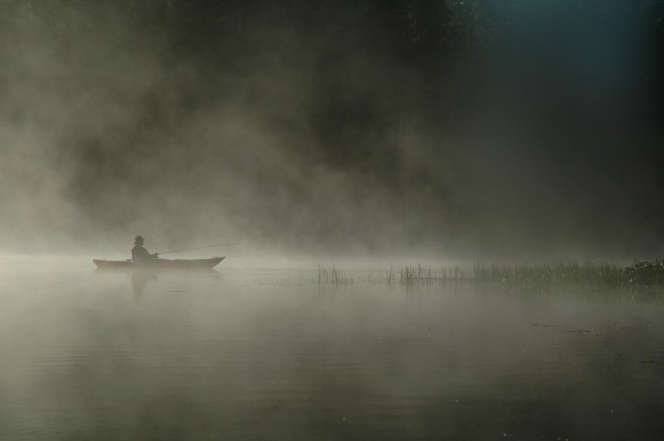 Person Riding Boat On Body Of Water
