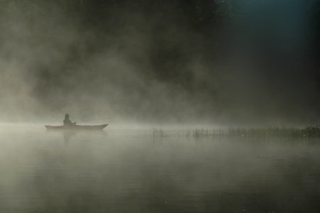 Person Riding Boat On Body Of Water photo