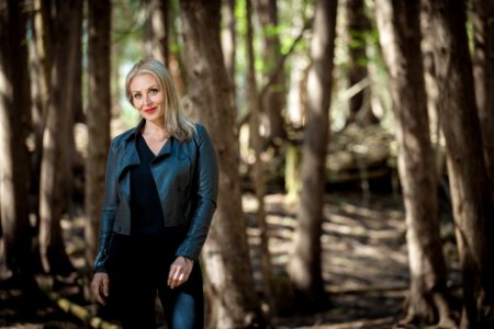 Woman Wearing Black Leather Jacket In Forest photo