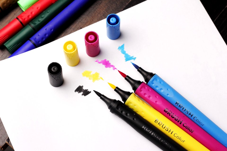 Brush Colouring Pens On Top Of White Paper