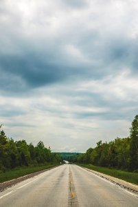 Empty Blacktop Road Under Cloudy Sky photo