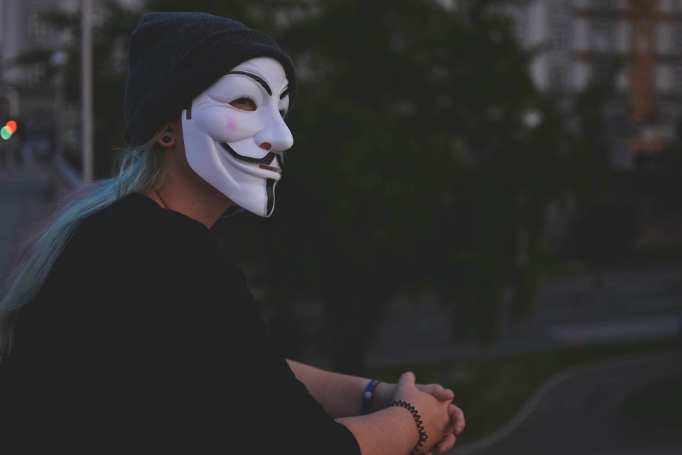 Woman Wearing White Guy Fawkes Mask photo