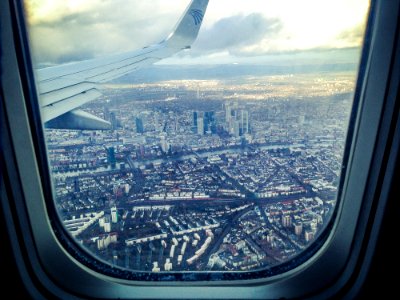 Airplane Windowpane Showing City Buildings photo