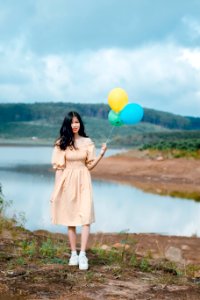 Shallow Focus Photography Of Woman Holding Balloons photo