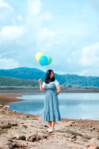 Woman Holding Balloons Near River photo