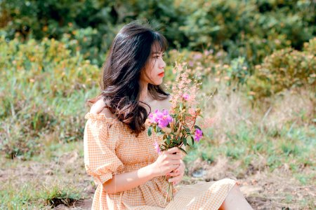 Woman In Dress Holding Flowers photo