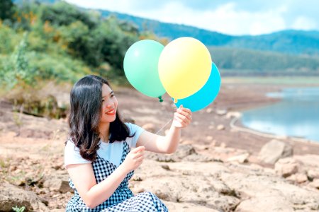 Woman In White And Black Dress Holding Three Balloons