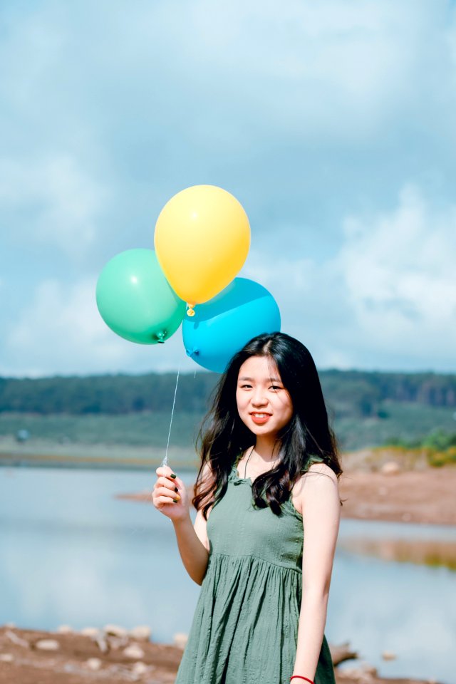 Woman In Green Sleeveless Top Holding Balloons