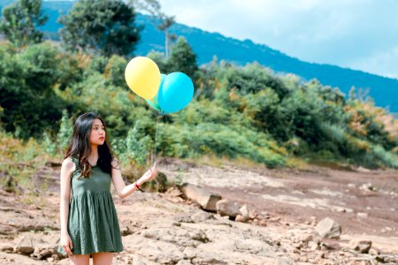 Portrait Photography Of Woman Holding Balloons photo