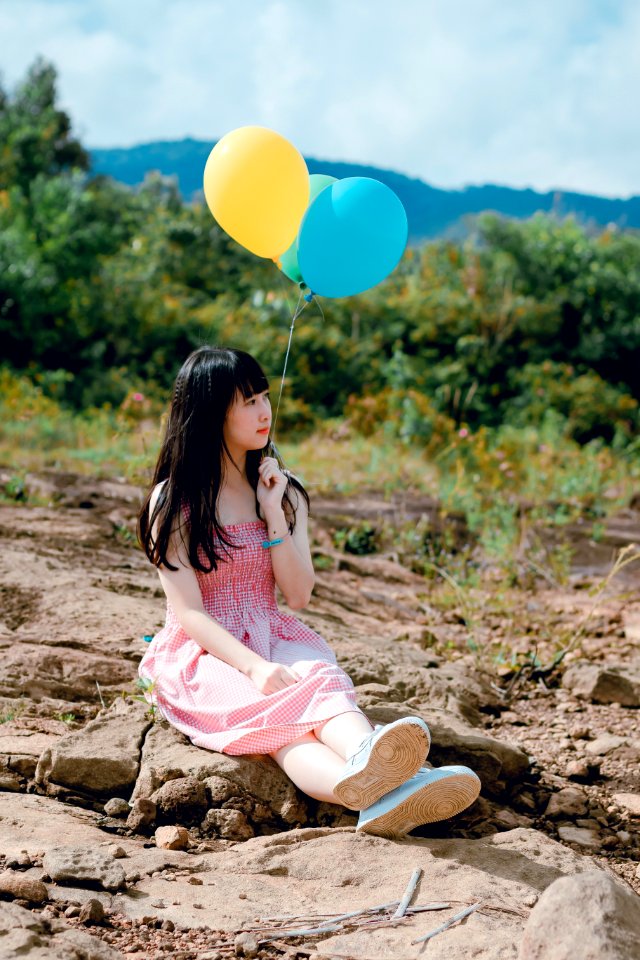 Photo Of Woman Holding Balloons photo