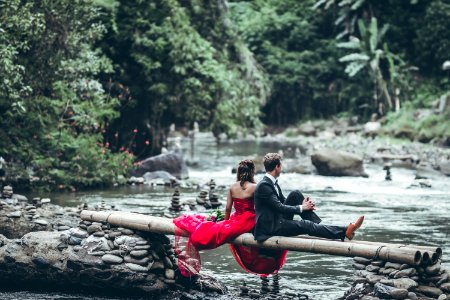 Man And Woman Sitting On Bamboos photo
