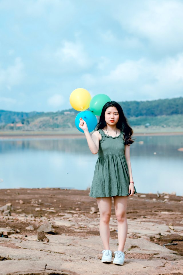Woman Holding Three Balloons