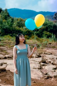 Photography Of A Woman Holding Balloons photo
