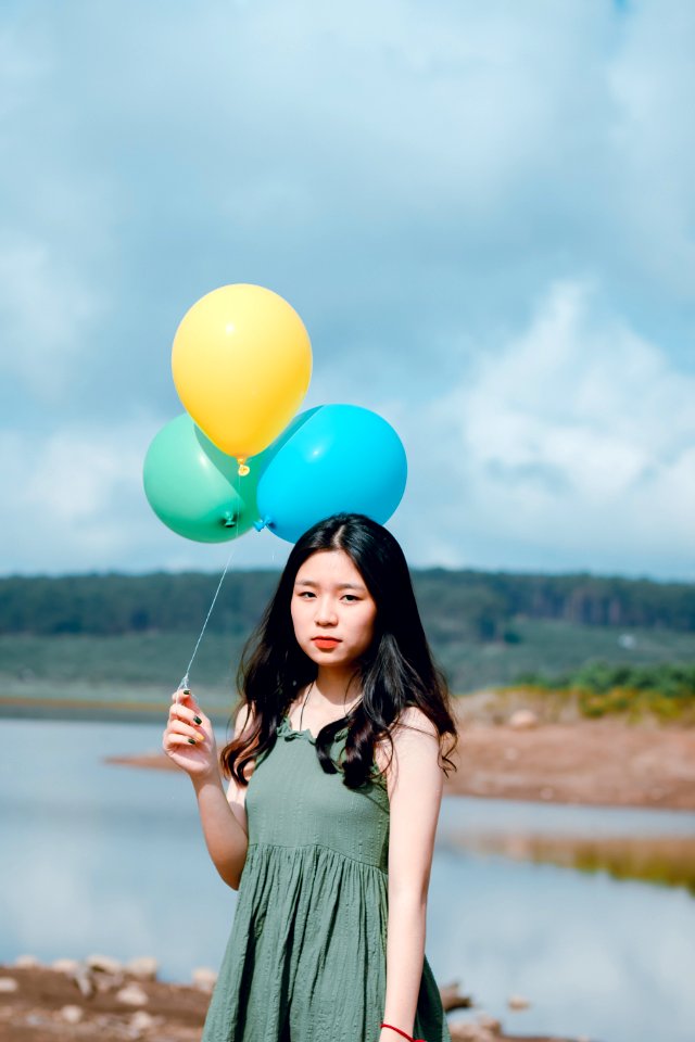 Woman Wearing Dress Holding Balloons photo