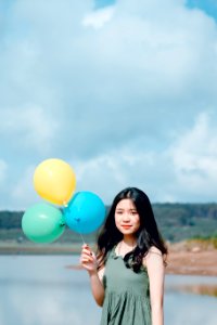 Woman In Green Sleeveless Top Holding Balloons photo