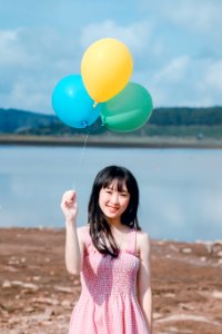 Photo Of Woman Holding Balloons
