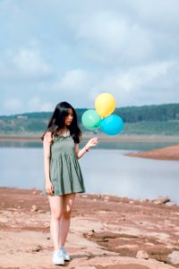 Woman In Green Sleeveless Dress Holding Balloons photo