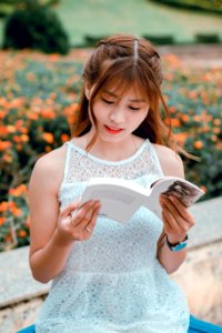 Selective Focus Photography Of Woman Reading A Book photo