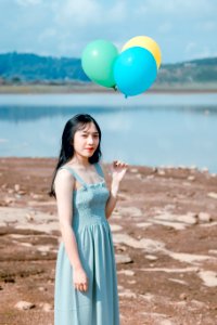 Photography Of A Woman Holding Balloons photo