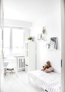 Plush Toys On Top Of White And Grey Mattress Inside Bedroom photo