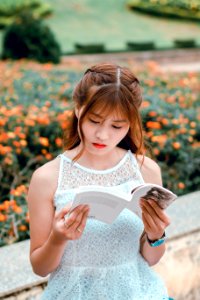 Woman Wearing White Sleeveless Dress Reading Book photo