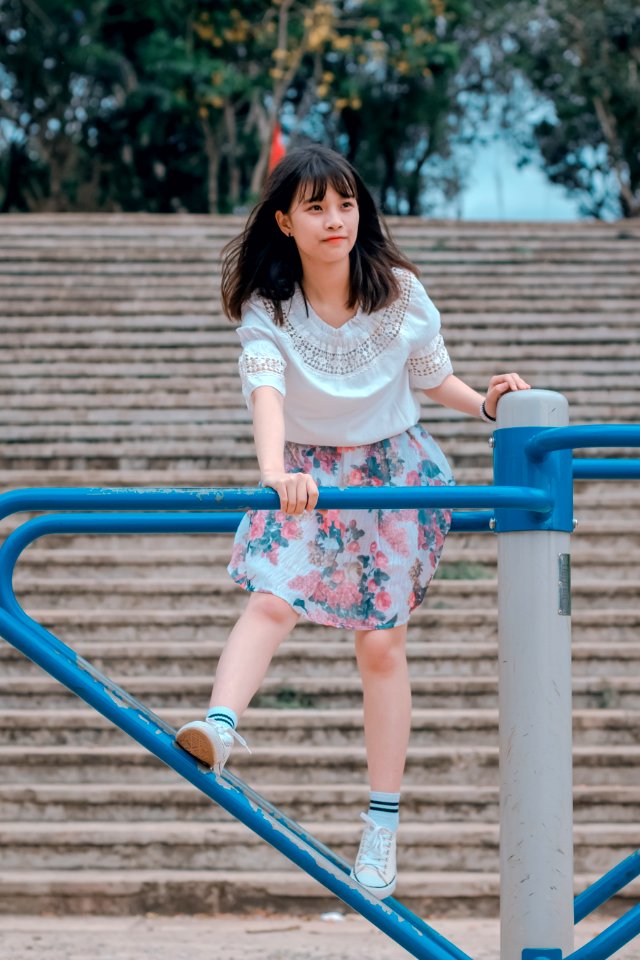 Woman Wearing White Blouse And Multicolored Floral Skirt Riding Merry-go-round