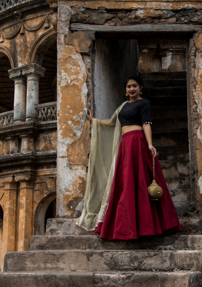 Woman In Red And Black Dress Posing For A Photo