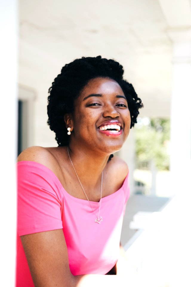 Smiling Woman Wearing Pink Off-shoulder Top photo