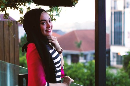 Woman Standing On A Balcony