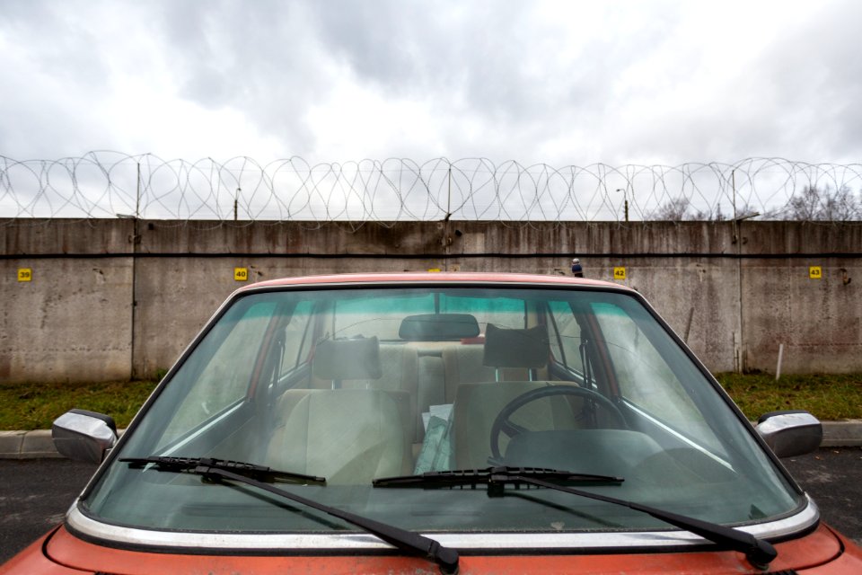 Closeup Photo Of Red Car Near Concrete Wall