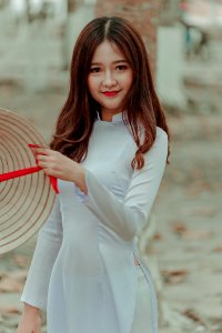 Woman Wearing White Long-sleeved Dress Holding Straw Hat photo