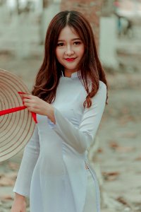 Woman Wearing White Long-sleeved Dress Holding Straw Hat