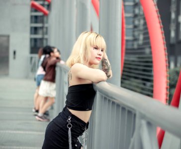 Photo Of Woman Leaning On Railing photo